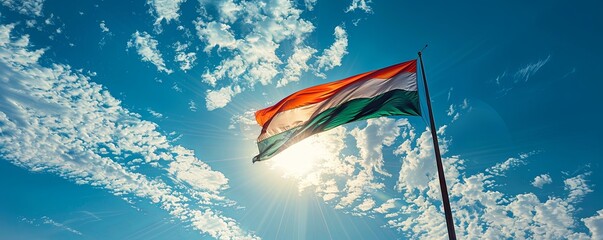 Madagascar flag flying against a bright, blue sky