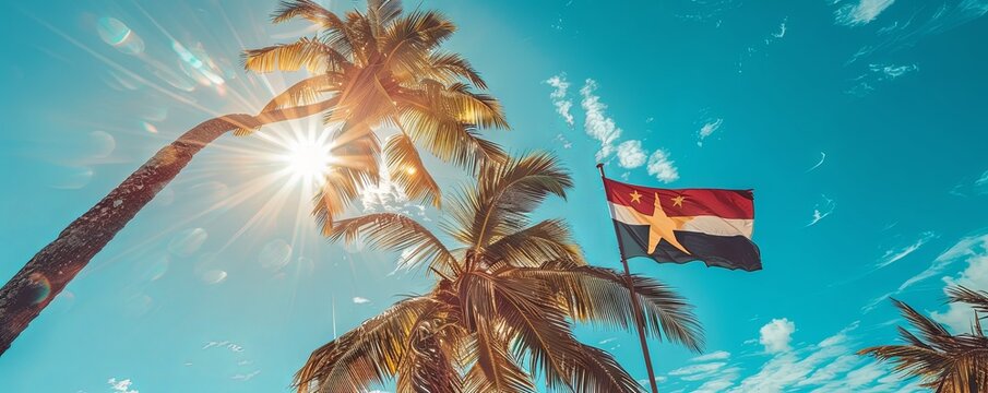 Antigua and Barbuda flag waving against a clear, sunny sky
