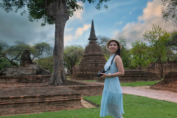 woman in the park. Beautiful woman  is travel on holiday in Ayutthaya, Thailand. People walking  on Ayutthaya Historical Park, Thailand.