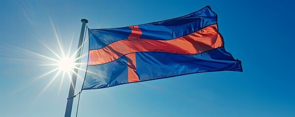 Iceland flag waving against a clear, sunny sky