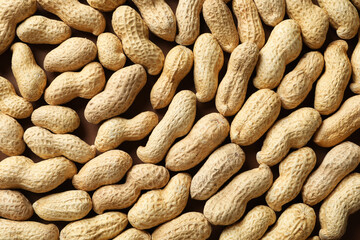 Many fresh unpeeled peanuts as background, top view