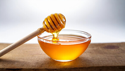 glass bowl filled with golden honey, accompanied by a wooden honey dipper, isolated on a white background. The honey's rich color and smooth texture are emphasized, representing natural sweetness and 