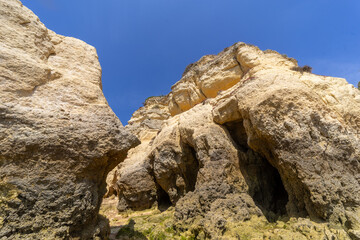 Armsau de Pera, natural rocky shore by the ocean, Portugal