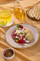 red beetroot hummus with falafel, lemon, sesame, olive oil, pita. Middle eastern, Jewish, arabic cuisine.