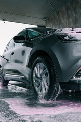 Car washing. Cleaning Car Using High Pressure Water
