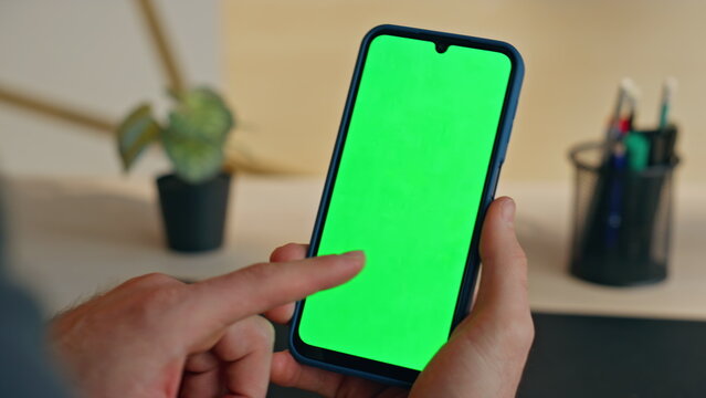 Manager finger touching mockup smartphone workplace closeup. Man swiping phone