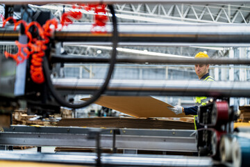 Fototapeta premium technician engineers checking the process on Heavy machine. mechanical engineering team production. Industry manufacturing. Worker holding tablet and folde. High technology production.