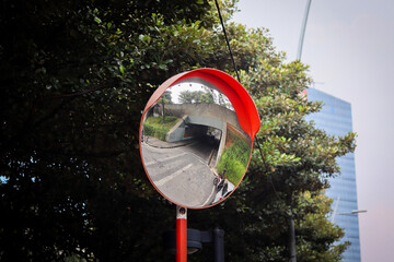 Vibrant orange convex mirror installed at intersections or bends for safety and visibility