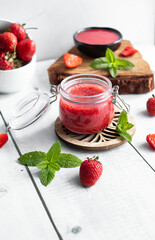 Fresh strawberry jam. on a wooden background. berries