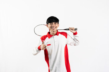Young Asian man wearing Indonesian clothing is holding a racket and playing badminton. isolated white background