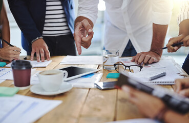 Business people, hands and pointing with tablet and documents in meeting for collaboration on project at office. Group of employees, conversation or discussion with paperwork for brainstorming