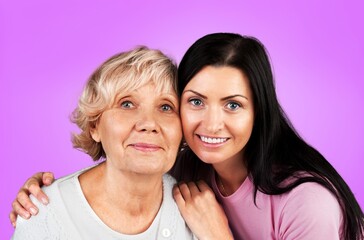 Beautiful young female hugging her mother