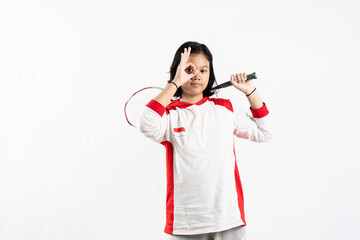 Young Asian woman wearing Indonesian clothing is holding a racket and playing badminton. isolated white background