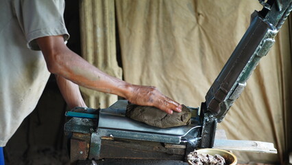 Making roof tiles from clay is done manually by craftsmen using their hands