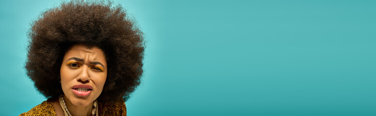 A stylish African American woman in trendy attire, looking surprised.