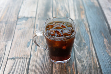 A cup of iced americano coffee on the table.