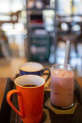 A cup of iced americano coffee on the table.
