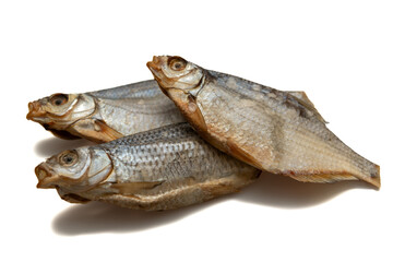 A lot of dry salted fish on a white background. Delicious salty snack.