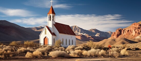 An ancient church stands amidst a desert landscape with majestic mountains in the backdrop. with copy space image. Place for adding text or design