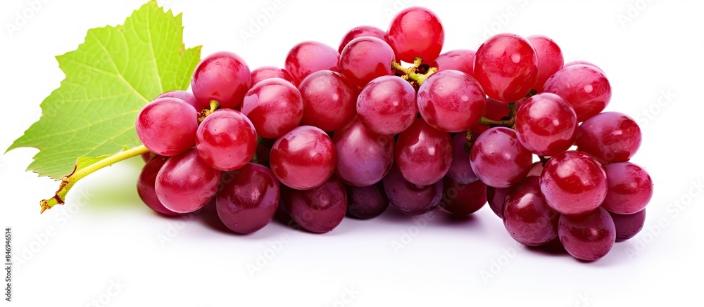 Leinwandbilder close-up view of a cluster of red grapes along with a leaf, isolated on a white background. with cop