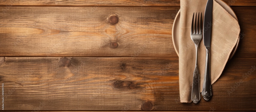 Fototapete fork and knife neatly placed on a napkin, alongside a dish, set on a rustic wooden background. with 