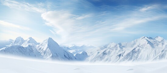 Obraz premium Mountains enveloped in fresh powder snow, with peaks visible beneath the cloud-filled sky. with copy space image. Place for adding text or design