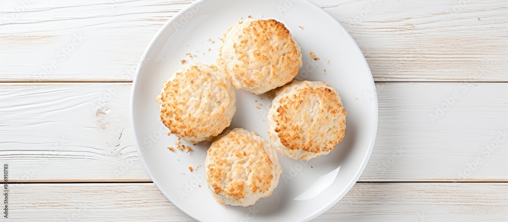 Poster cottage cheese biscuits displayed on a white plate atop a wooden table, ideal for a delicious homema