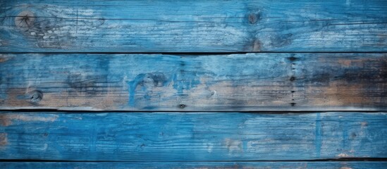 Fototapeta premium Weathered blue wooden wall with peeling paint, creating a rustic and textured background. with copy space image. Place for adding text or design