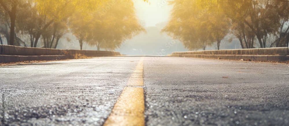 Poster street devoid of vehicles with a prominent yellow line marking the road surface. with copy space ima