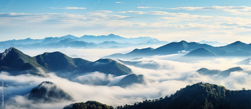 Aufkleber Misty mountains in the distance with low clouds and a sea of clouds nestled between them, creating a serene and mystical landscape. with copy space image. Place for adding text or design