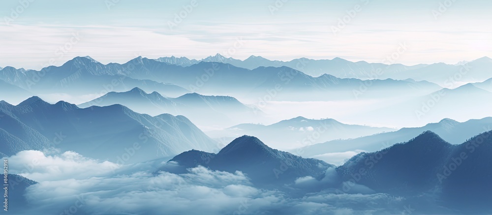 Aufkleber Scenic view of misty mountain range with clouds in the foreground and a sea of mist between the peaks. with copy space image. Place for adding text or design