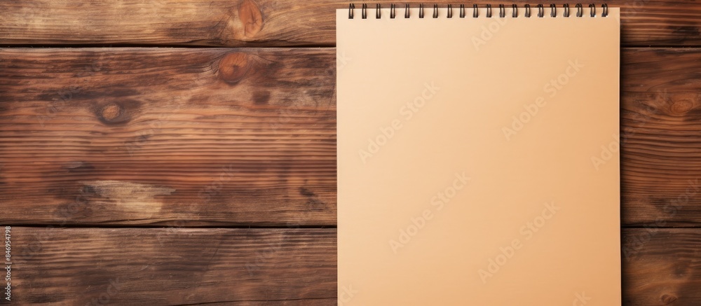 Aufkleber Notepad with empty pages positioned on a table made of wood. with copy space image. Place for adding text or design