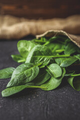 Pile of spinach leaves close-up on a black background