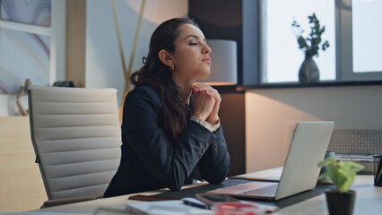 Pensive businesswoman resting desk at workplace. Woman taking break thinking