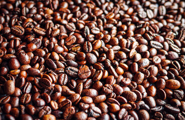 Top view of backdrop dark brown coffee beans and Textured background of freshly roasted coffee beans
