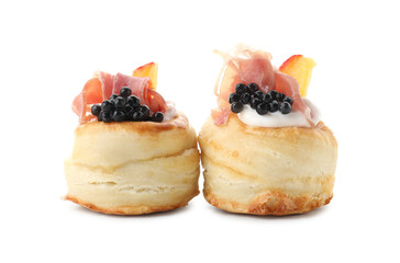 Delicious puff pastry with cream cheese, ham, black caviar and peach isolated on white