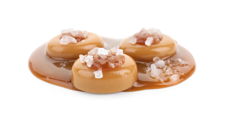 Yummy candies with caramel sauce and sea salt isolated on white