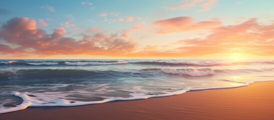 Fototapeta premium Sunset view of the sea from the sandy beach with waves gently crashing on the shore. with copy space image. Place for adding text or design
