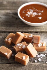 Yummy caramel candies with sea salt on wooden table, closeup