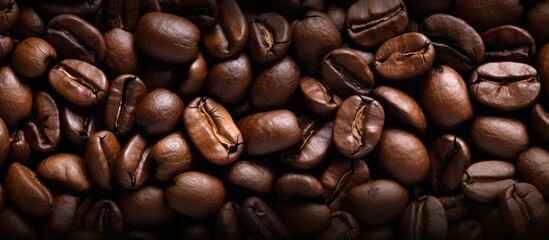 Fototapeta premium Macro shot of textured roasted coffee beans in a close-up view. with copy space image. Place for adding text or design