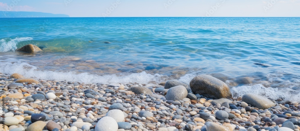 Aufkleber Scenic view of rocky seashore with small pebble beach, waves carrying foam. with copy space image. Place for adding text or design