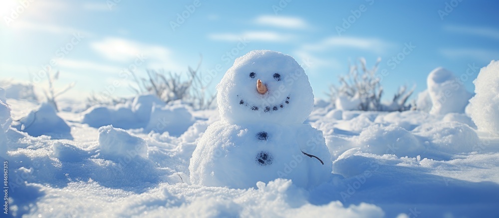Poster snowman standing tall in snowy landscape under bright blue sky. with copy space image. place for add