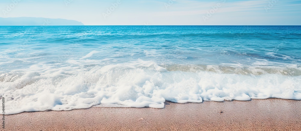 Aufkleber A view of the seaside with a wave rolling toward the sandy shore, setting a backdrop for a summer vacation theme. with copy space image. Place for adding text or design