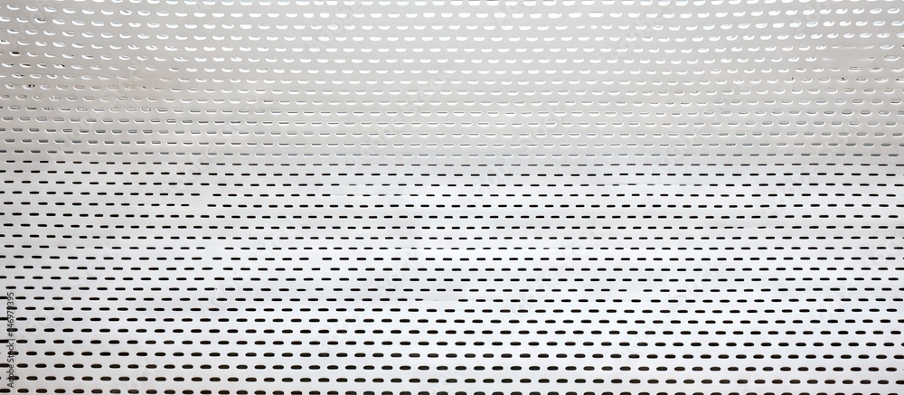 Poster close-up view of a white painted metal sheet with perforations. with copy space image. place for add