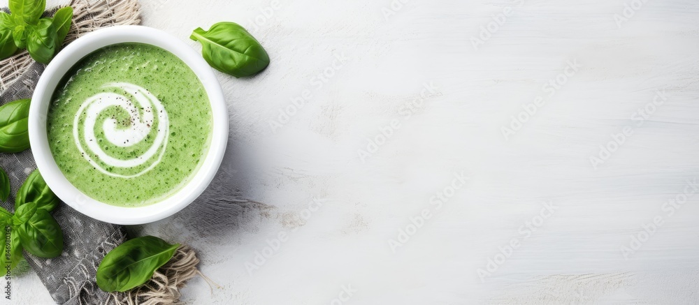 Poster creamy spinach soup with fresh basil served in a white bowl on a rustic tabletop. with copy space im