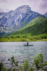 A beautiful view on the Ehrwalder Almsee and the Zugspitze on a sunny summer day in Austria, 2024, pescadores, haciendo su labor del dia para llevar comida a casa