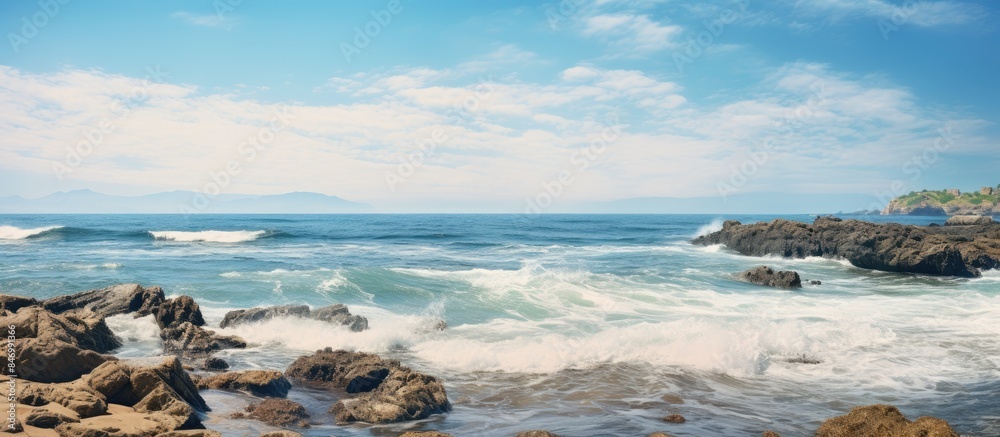Aufkleber Rocky coast with shoaling beach and waves crashing on the rocks creating a serene coastal scene. with copy space image. Place for adding text or design