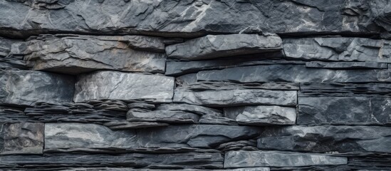 Textured monochrome photo featuring a detailed rock wall surface for background or texture purposes. with copy space image. Place for adding text or design