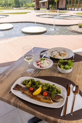 Grilled fish served on a plate in the restaurant