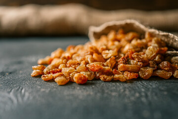 Raisins spill out of a burlap bag
